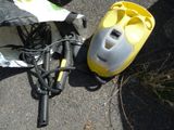 a yellow and black vacuum and a yellow and black bag on the ground