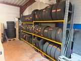 a lot of tires on the shelves in the garage