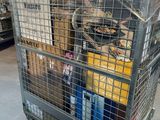 a metal cart with many items in it in a warehouse