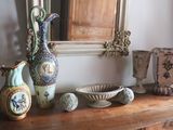 many vases and bowls sitting on a wooden table