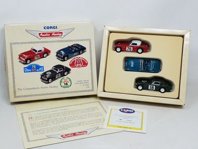 two boxed toy cars are in a box on a white surface