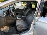 the interior of a car with the door open and the driver ' s seat down
