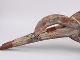 a close up of a wooden object on a white surface