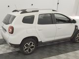 a picture of a white car parked in a garage