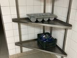 a metal shelf with baskets on it in a kitchen