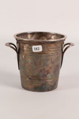 an antique silver plated wine bucket with handles on a white background