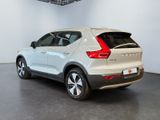 the rear of a white volvo suv parked in a showroom