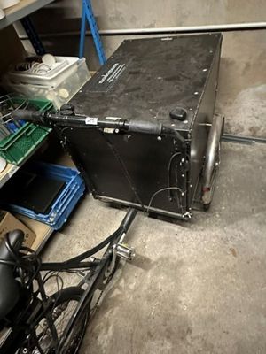 a black suitcase sitting on the floor next to a bike