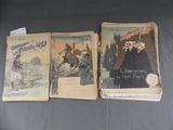 trois livres sont posés sur une table à fond noir