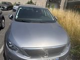 a silver car parked in a parking lot next to a building