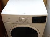 a white washer and a dryer in a small room