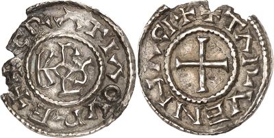 a silver coin with a cross on the front and a cross on the back