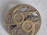 a coin with a gun on it on a white surface
