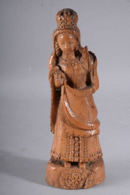 an image of a wooden statue of a woman holding a bag