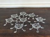 a lot of glass flowers on a wooden floor