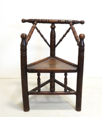 a wooden chair that has a wooden seat on it