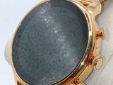 a close up of a watch on a display stand
