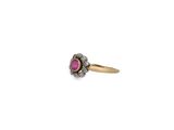 a close up of a gold ring with a pink stone