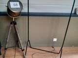 a lamp that is on a tripod stand next to a lamp