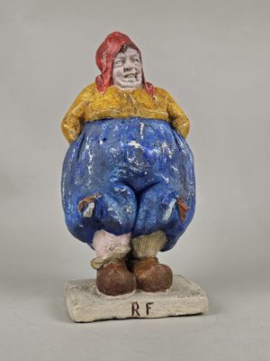 an image of a figurine of a man sitting on top of a rock