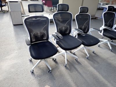 four office chairs that are lined up in a row