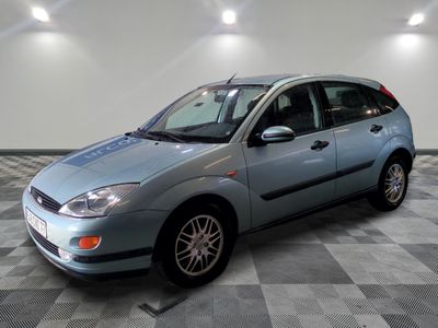 a picture of a blue ford focus parked in a garage