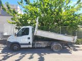 a white truck that is parked next to a tree