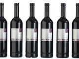 six bottles of red wine are lined up in a row
