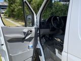 a white van with the door open and the driver ' s seat down