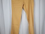 a pair of yellow pants hanging on a white curtain
