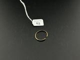 an image of a gold ring on a black surface