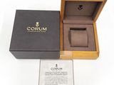 an open box with a watch inside of it on a white surface