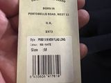 a person holding a tag that says born in portobello road west