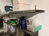 a kitchen with a stove, sink, and shelves in it