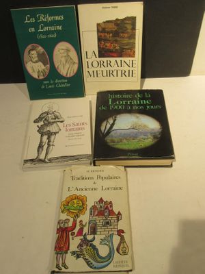 several books are sitting on a table in front of a lamp