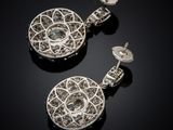 a pair of diamond and white gold earrings