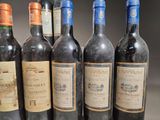 several bottles of wine are lined up on a table
