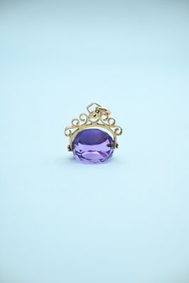 an amethorate ring with a crown on top of it