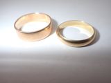 two wedding rings sitting on a white surface
