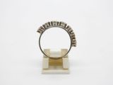 a white gold and diamond ring on a stand
