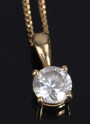 a close up of a diamond pendant on a black surface
