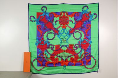 green, red, and blue silk scarf hanging on a wall