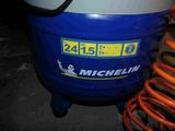 a blue and white air compressor sitting on top of a table