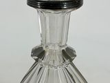 a clear glass vase with a black top