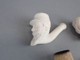 a pipe and a pipe holder sitting on a table