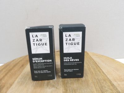two bottles of la zar tissue sitting on top of a wooden table