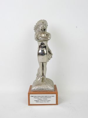 silver statue of a woman holding a baby on a wooden base