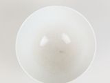 a white bowl that is sitting on a table