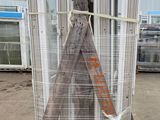 a large stack of metal poles on a pallet