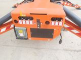 a small orange machine that is sitting on the ground